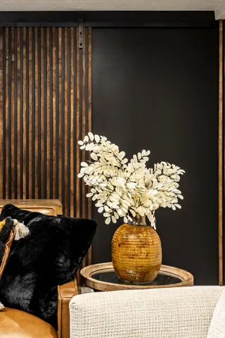Modern barn door with vertical wood paneling and matte black track hardware