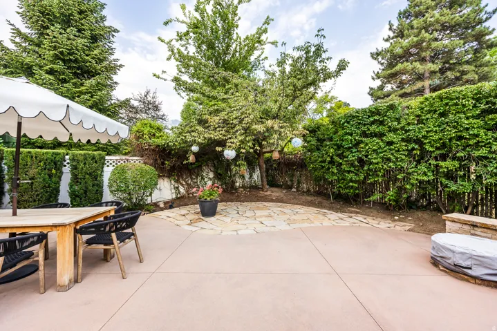 Expansive concrete patio area with a distinct flagstone section