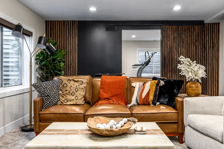 Cozy living space featuring a wood-slat accent wall, recessed lighting, and a modern barn door