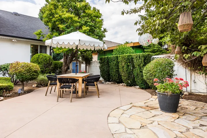 Curved concrete patio with flagstone accents