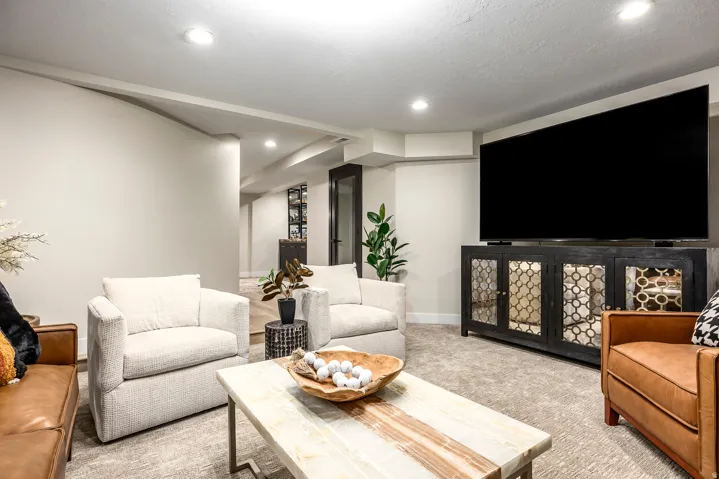 Recreational space featuring recessed lighting, light-toned carpeting, and a built-in media console with decorative glass panel doors