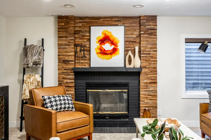 Fireplace featuring a stacked wood-finish surround and a black tile hearth