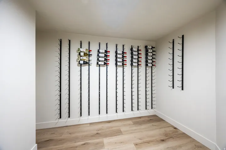 Dedicated wine storage room with extensive wall-mounted racks