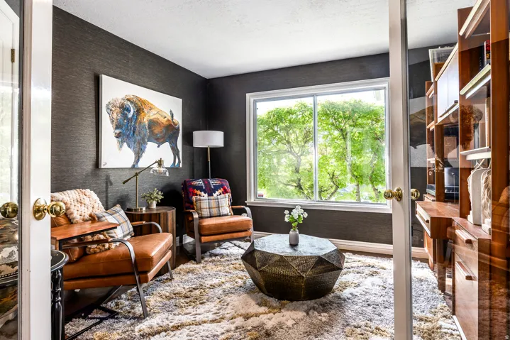 Textured dark accent wall with a large window