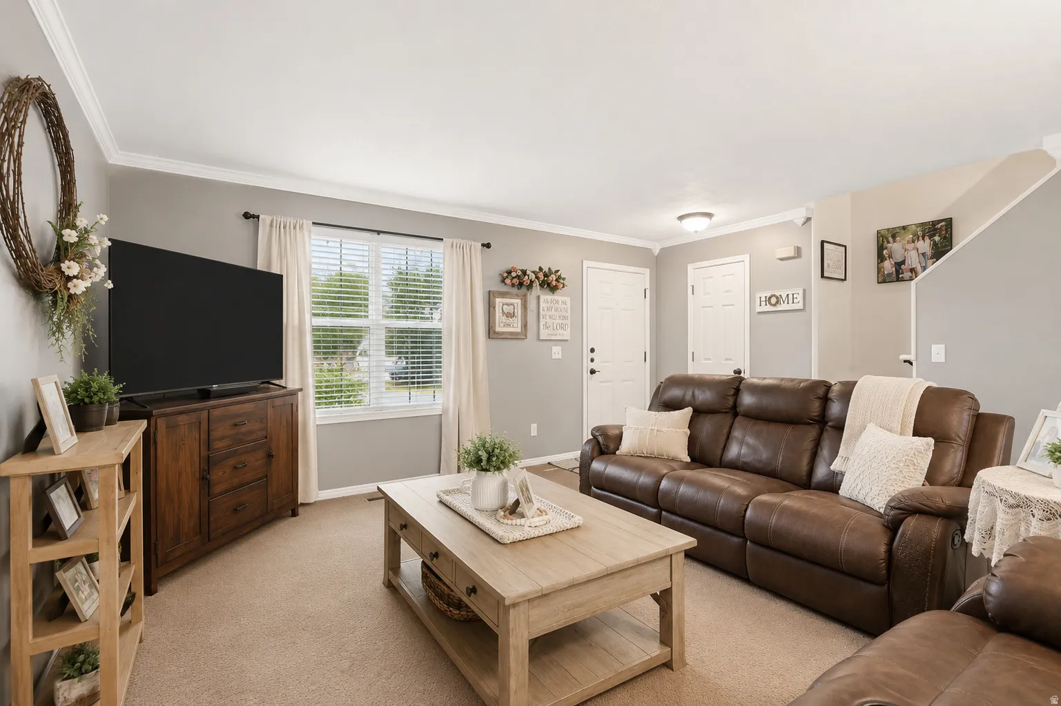 Living area with neutral wall color and crown molding