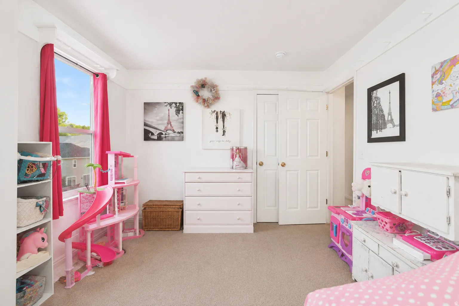 Bright room featuring a double-paned window, neutral carpet flooring, white painted walls, and white bi-fold closet doors