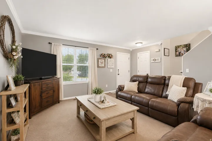 Living area with neutral wall color and crown molding
