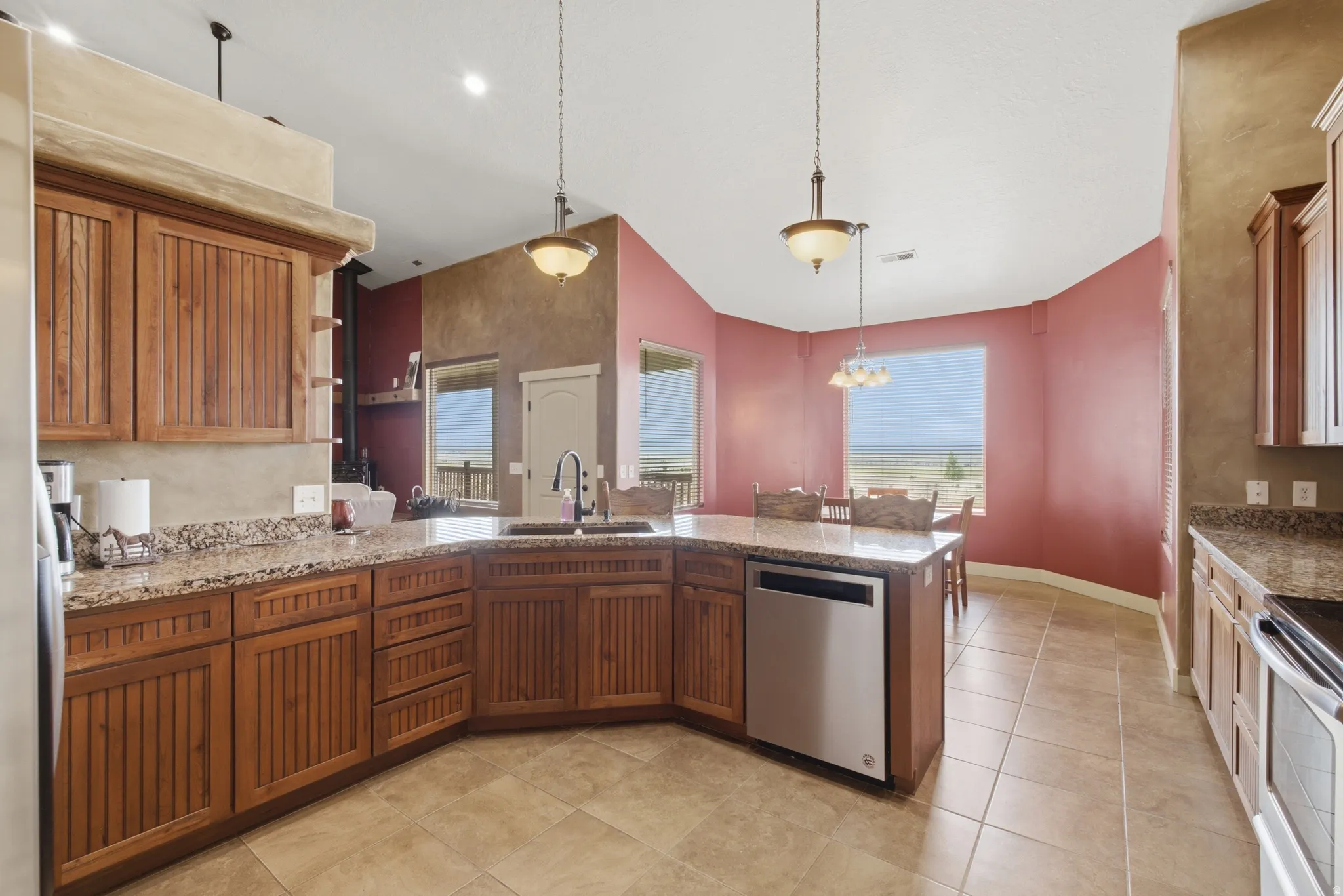 Kitchen featuring wood cabinetry, light-toned countertops, and tile flooring