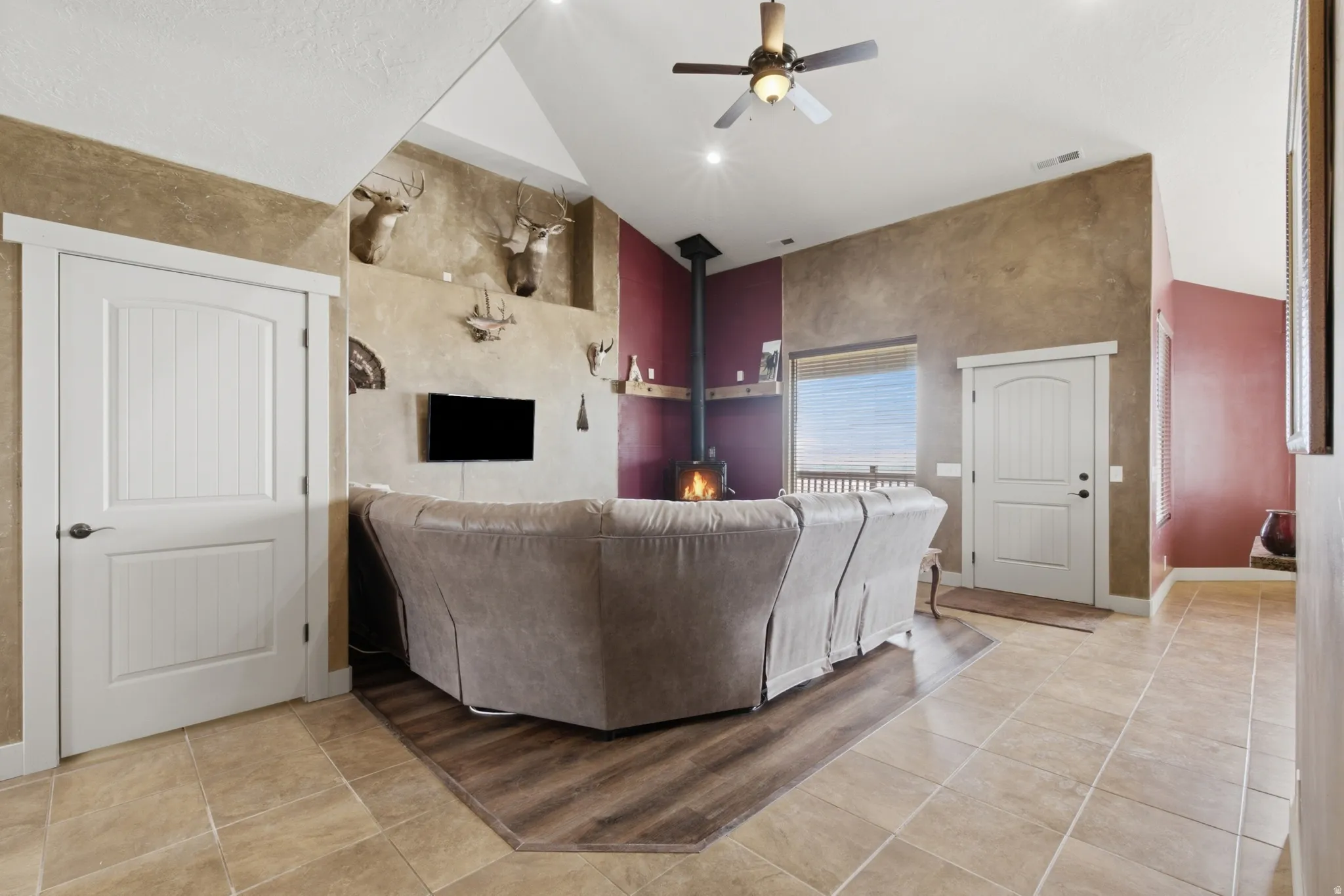 Great room featuring a vaulted ceiling with recessed lighting, a ceiling fan, and wood-finish flooring