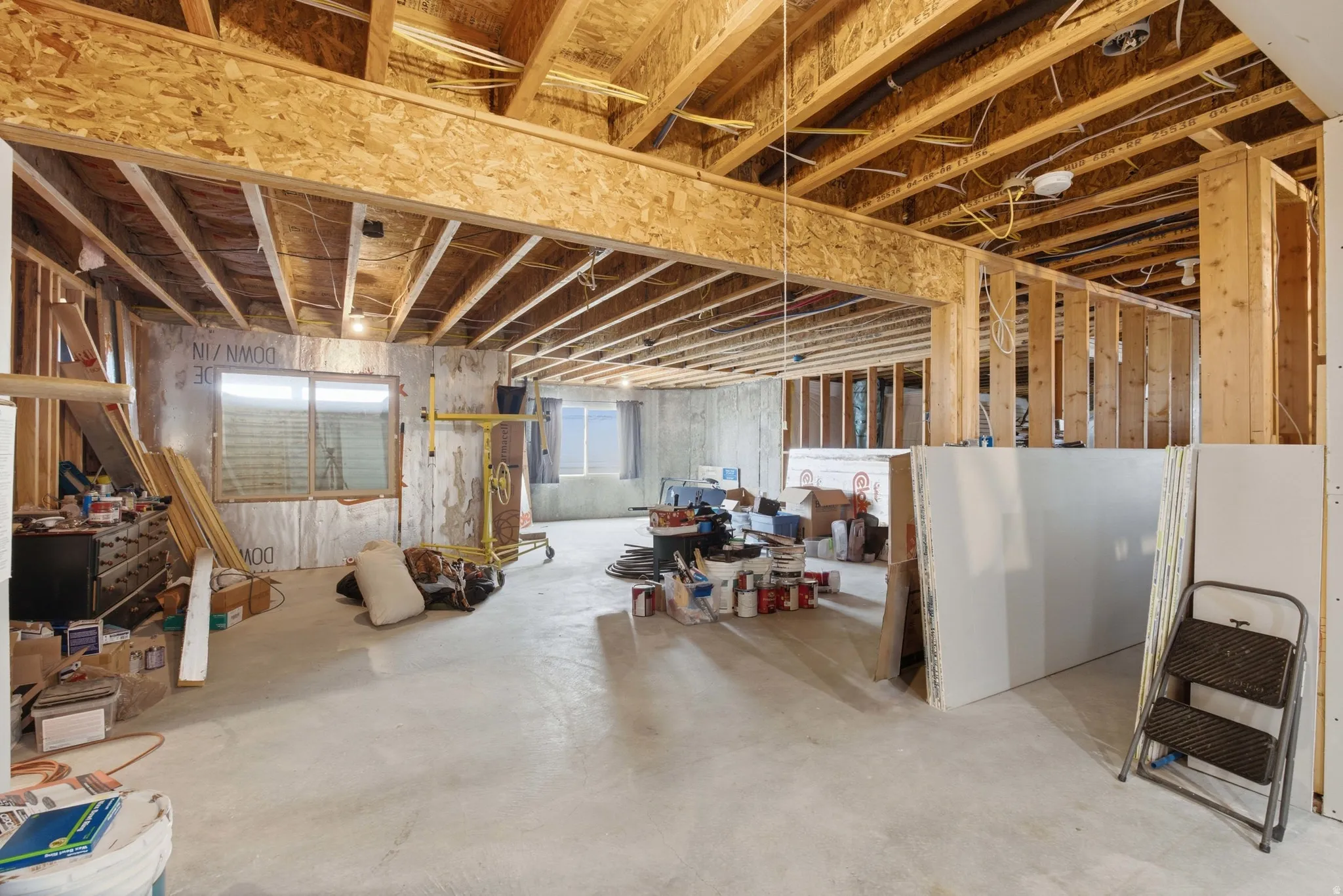 Unfinished lower level with concrete flooring