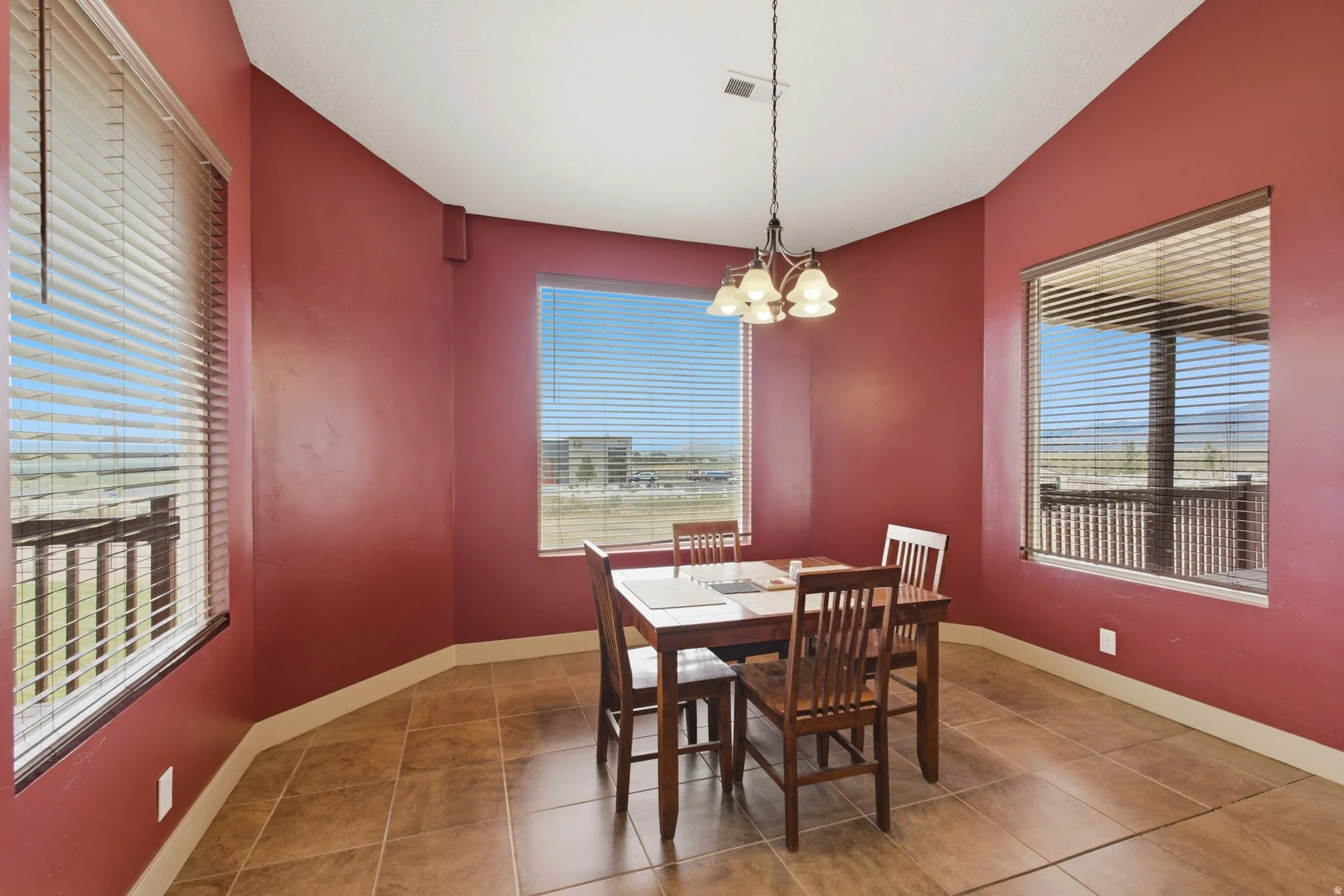 Dining area with tile flooring and a multi-paneled window
