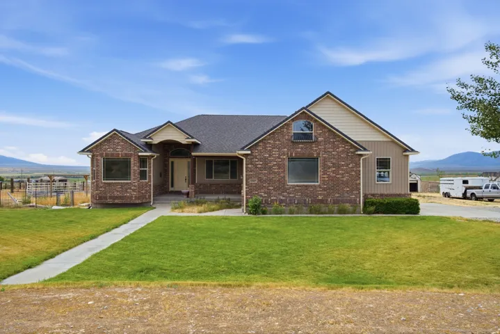 Brick and siding exterior featuring a covered entry and arched transom window