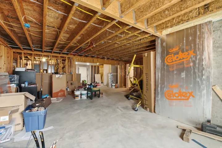 Unfinished basement with exposed wood framing and concrete flooring