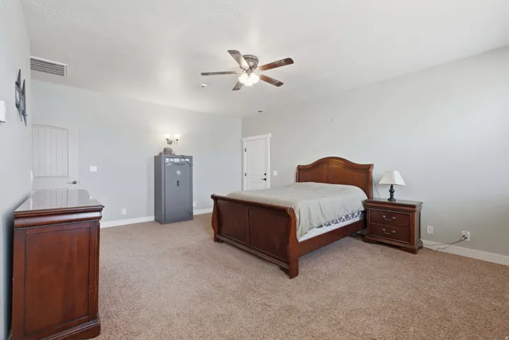 Spacious interior room featuring light-colored walls and textured carpeting