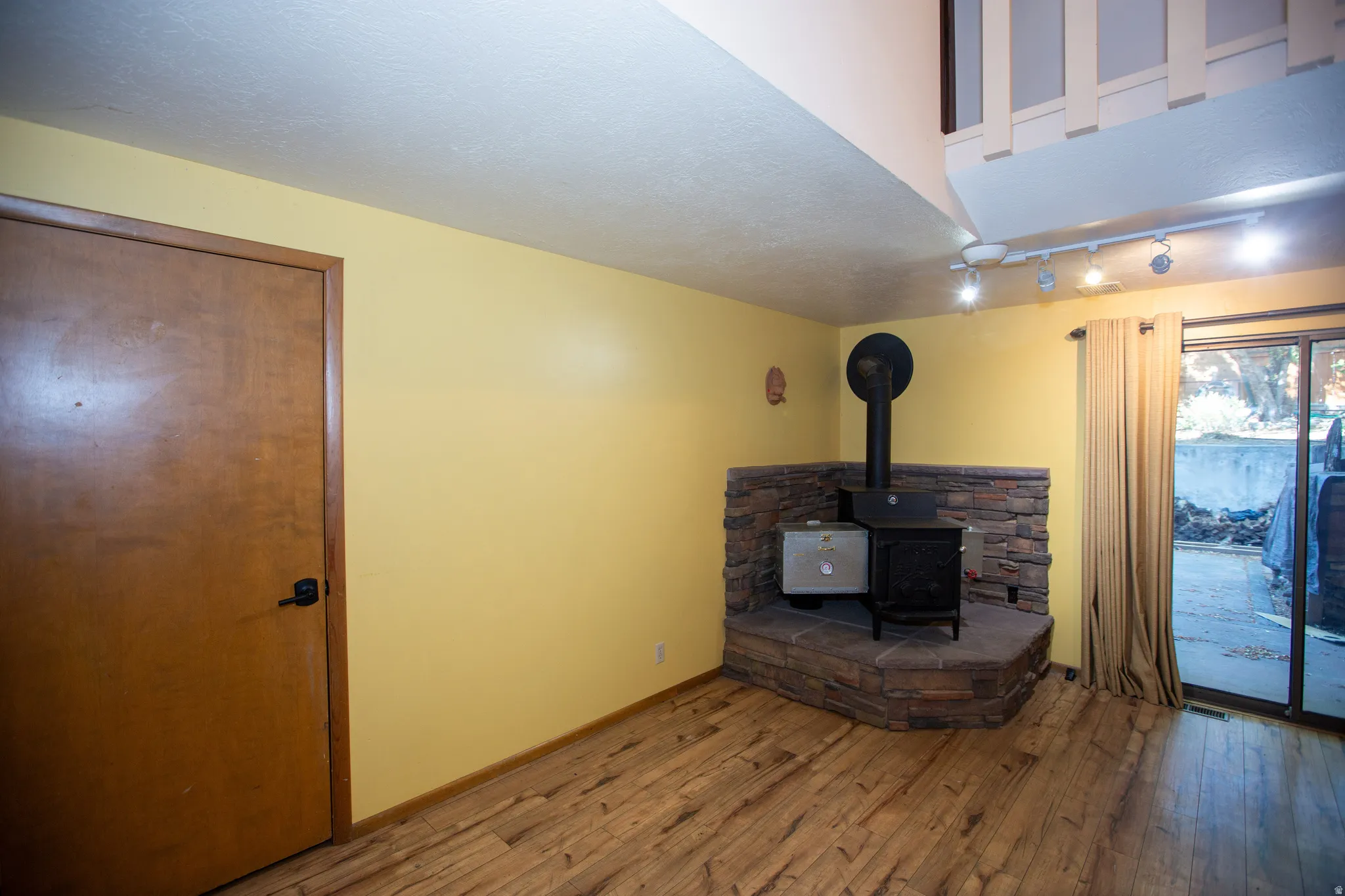 Corner wood stove with stone surround and hearth