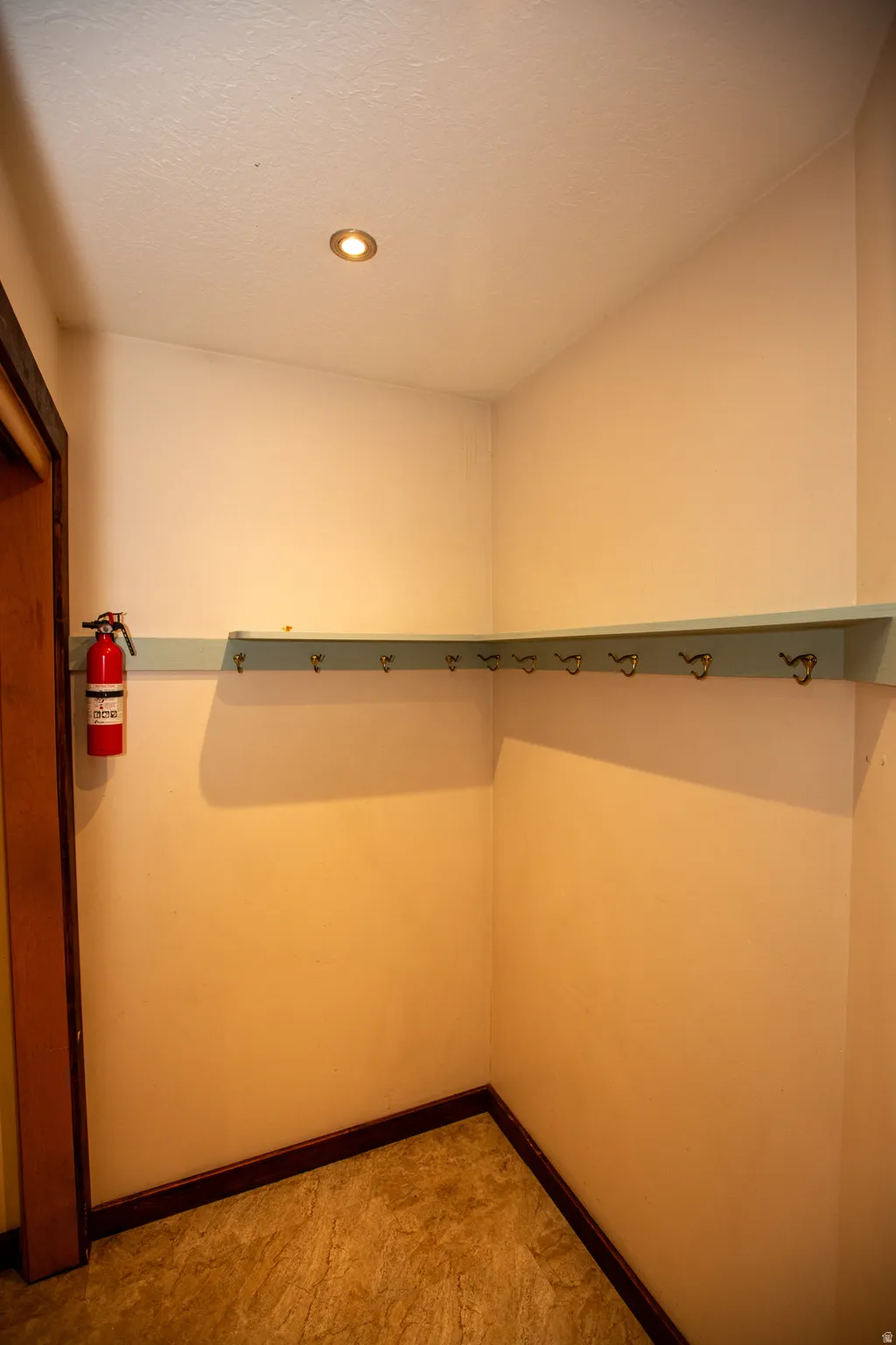 Mud room featuring a light blue shelf with hooks, recessed ceiling lighting, and wood-finish flooring