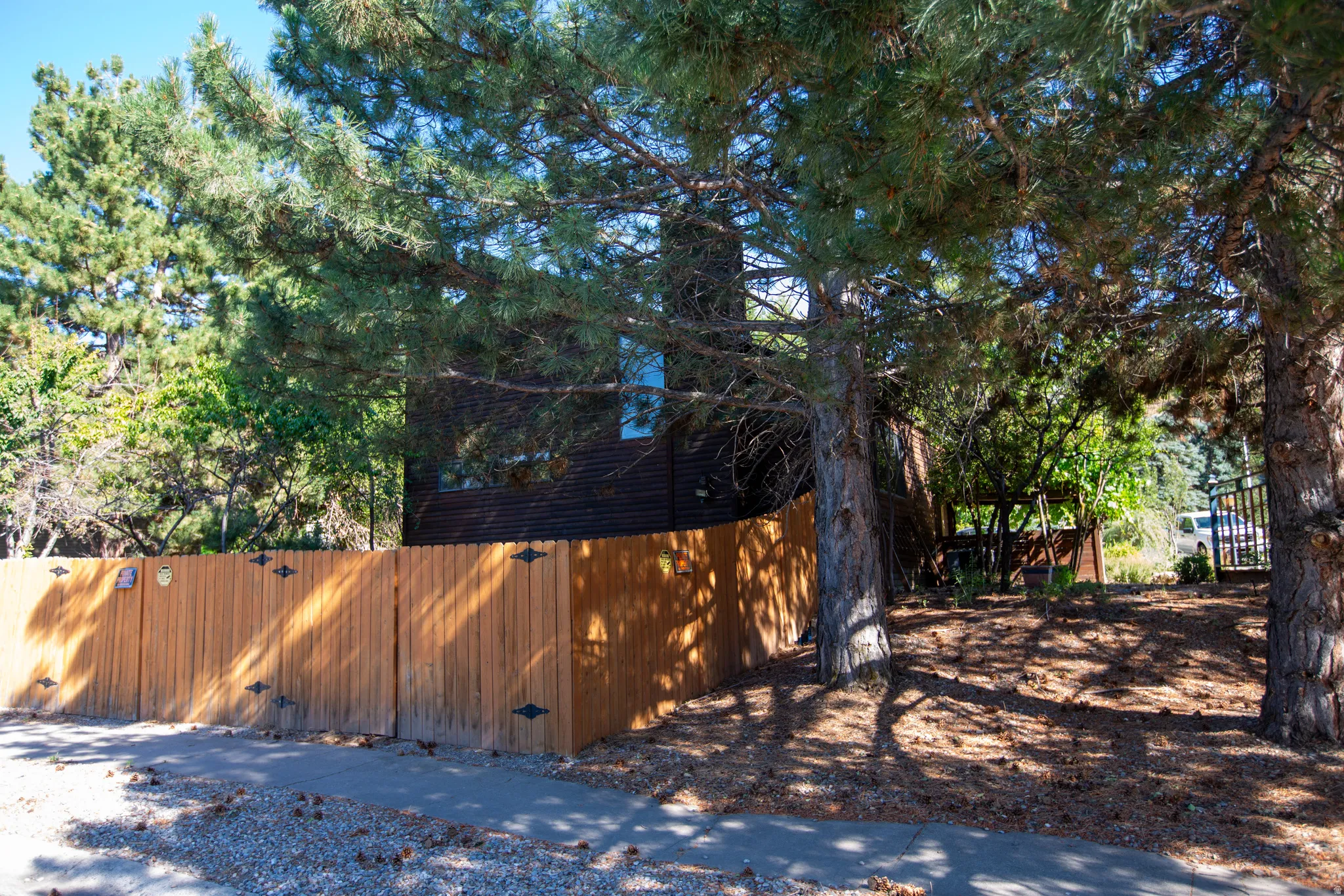 Natural wood privacy fence with decorative black hardware