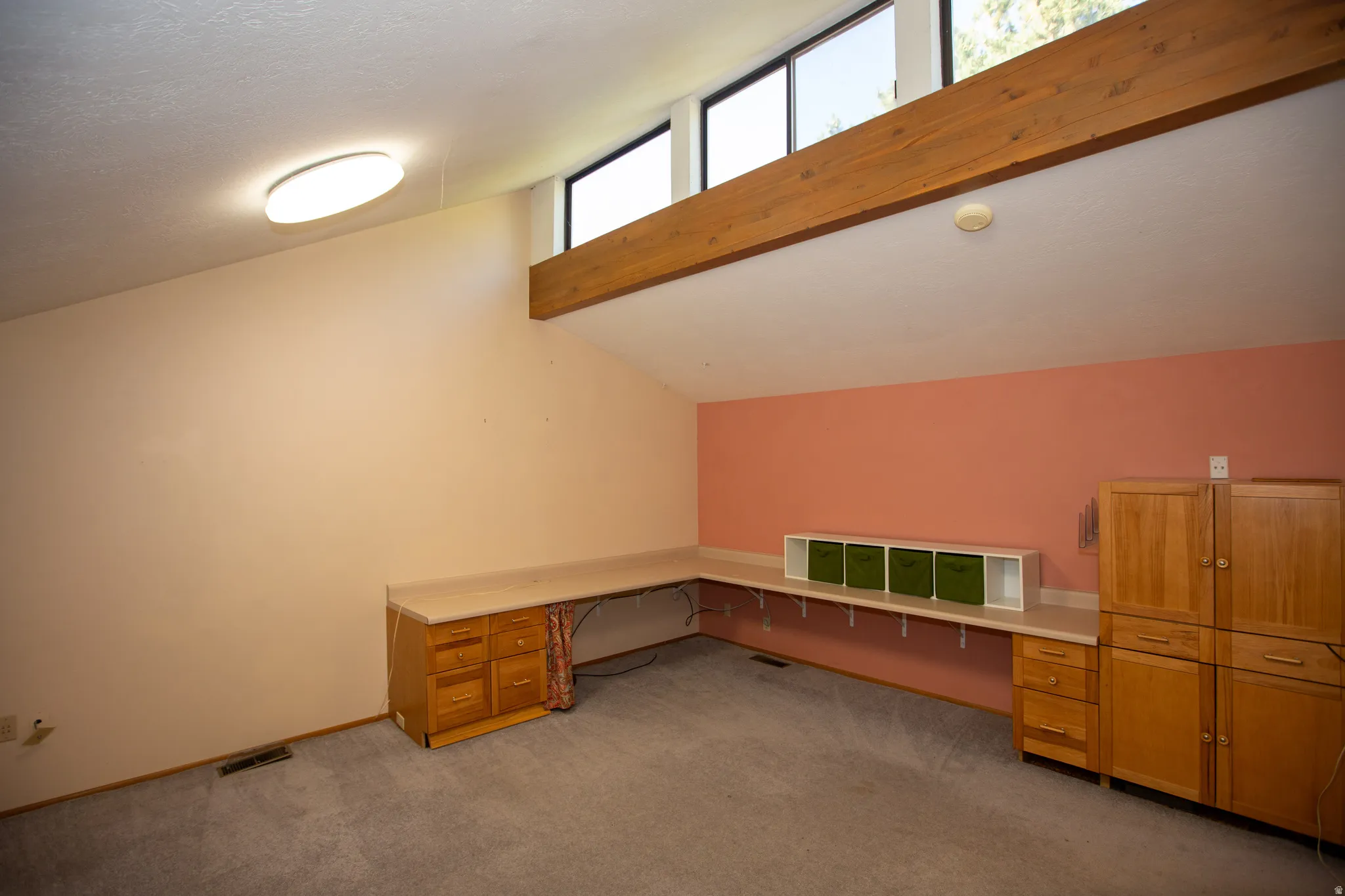 Vaulted ceiling with clerestory windows and exposed wood beam