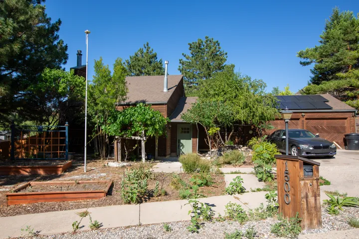 Property exterior with brown siding and a gabled roofline