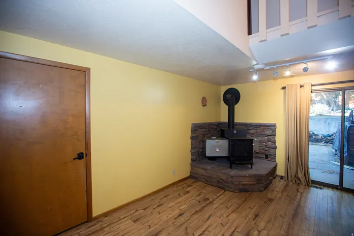 Corner wood stove with stone surround and hearth