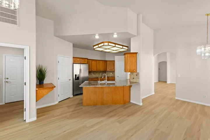 Open-concept living area featuring light wood-finish flooring