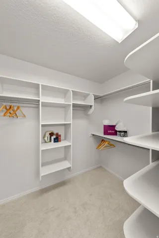 Custom closet organization system with multiple shelving units and hanging rods