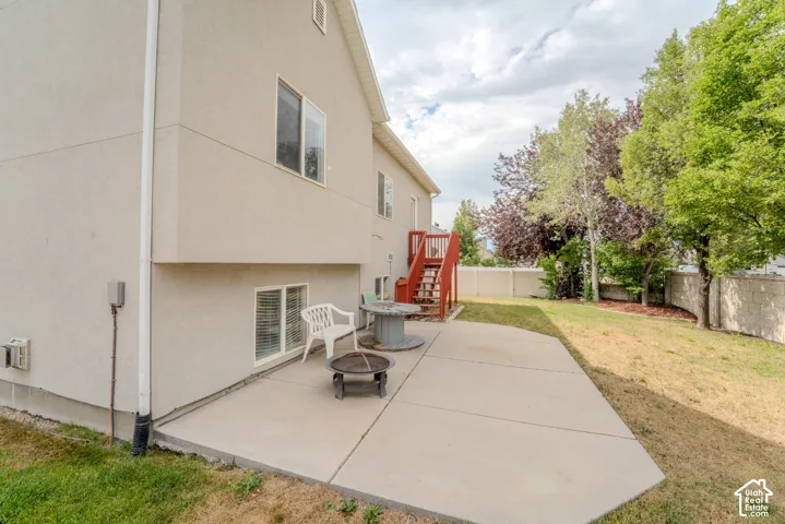 Rear exterior with a concrete patio