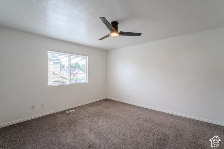 Room featuring neutral wall finishes and a textured carpet