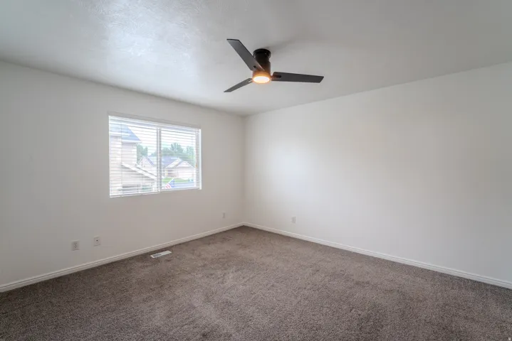 Room featuring neutral wall finishes and a textured carpet