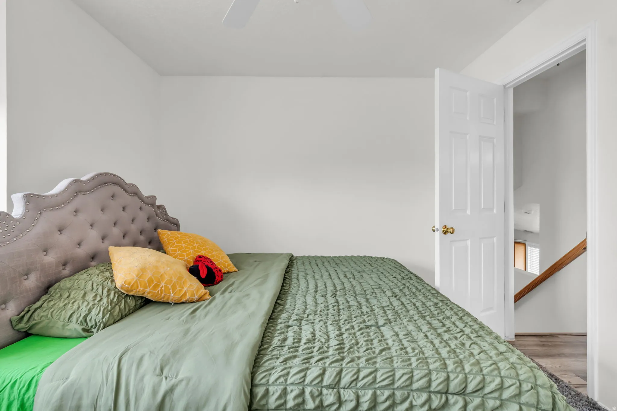 Room featuring white walls, a white ceiling, and a ceiling fan