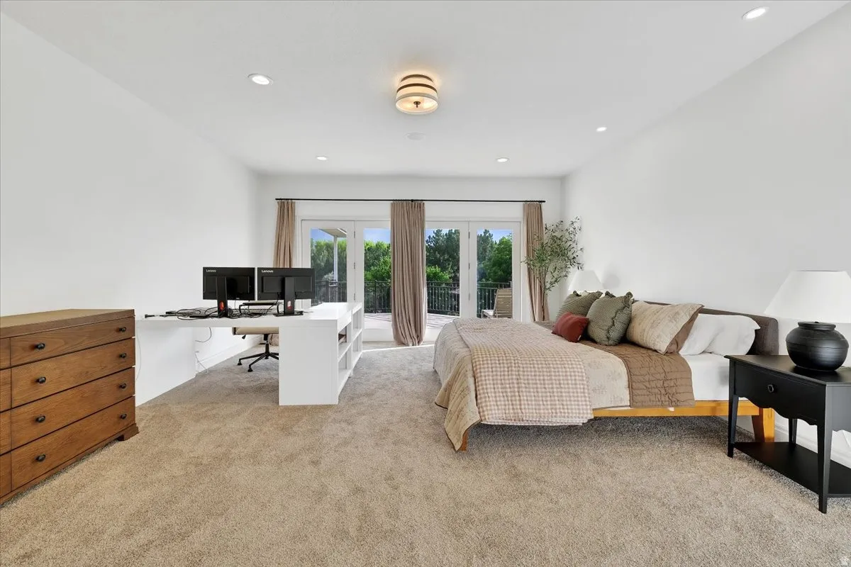 Carpeted room featuring a built-in white desk with shelving, recessed lighting, and a drum-style ceiling fixture