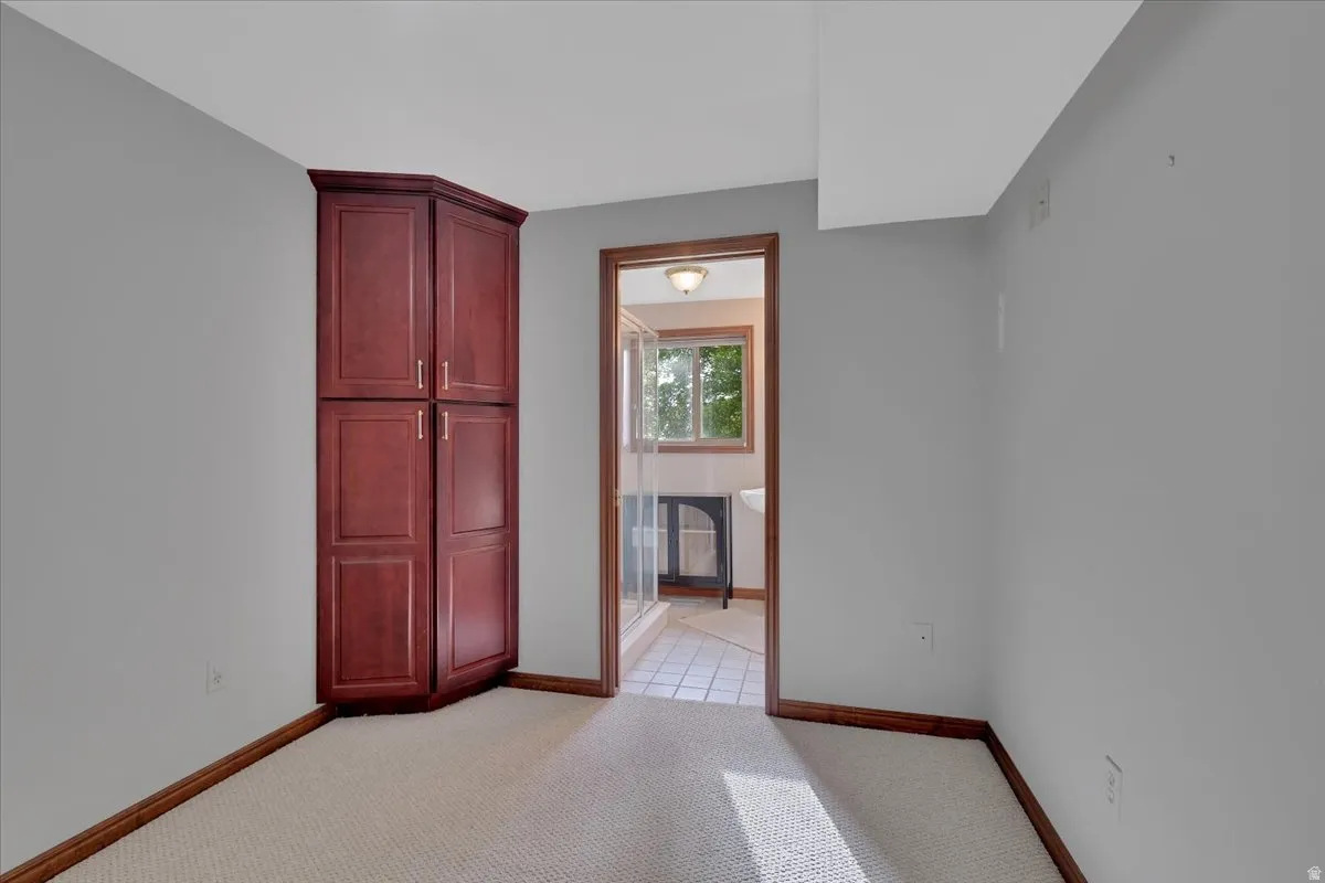 Corner built-in cabinetry provides storage in this neutral-toned room