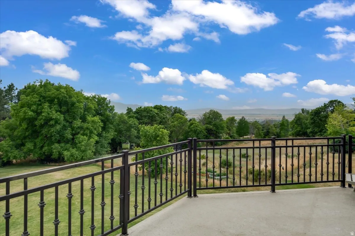 Outdoor balcony featuring a concrete surface and black metal balusters