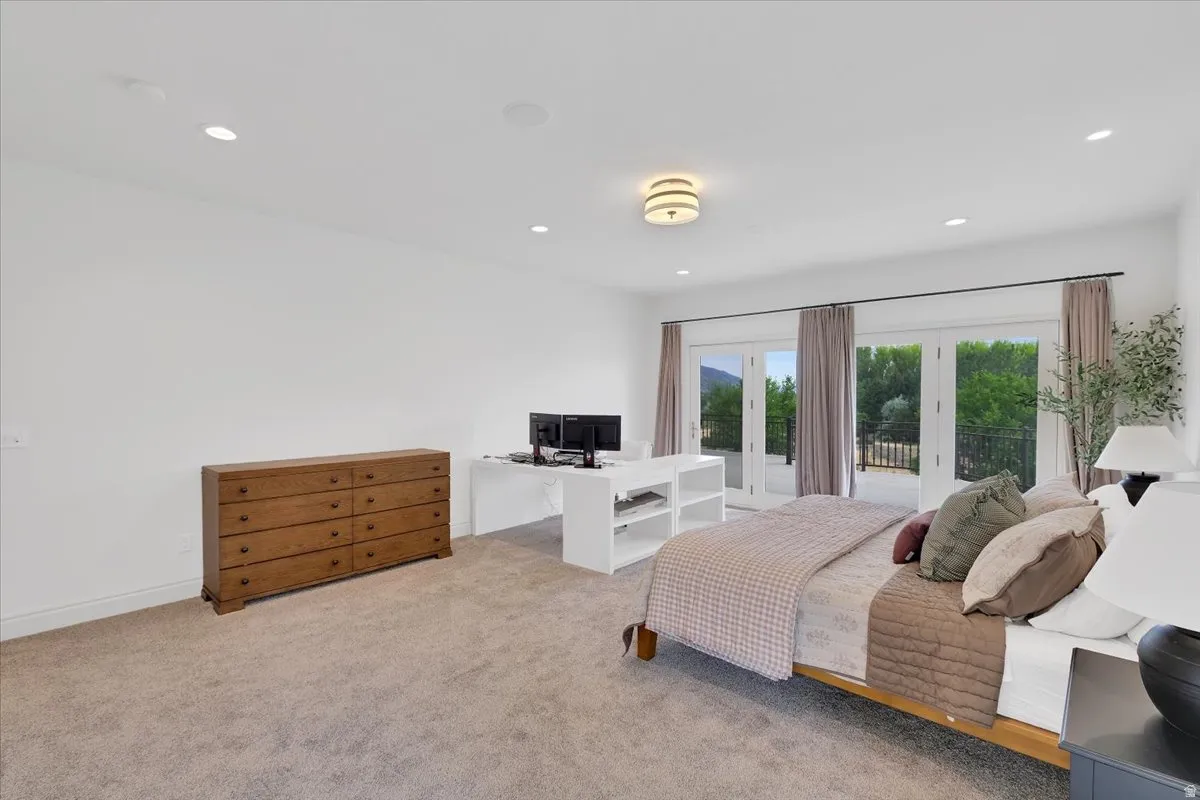 Spacious room featuring light-colored carpeting, recessed lighting, and a contemporary flush-mount ceiling fixture