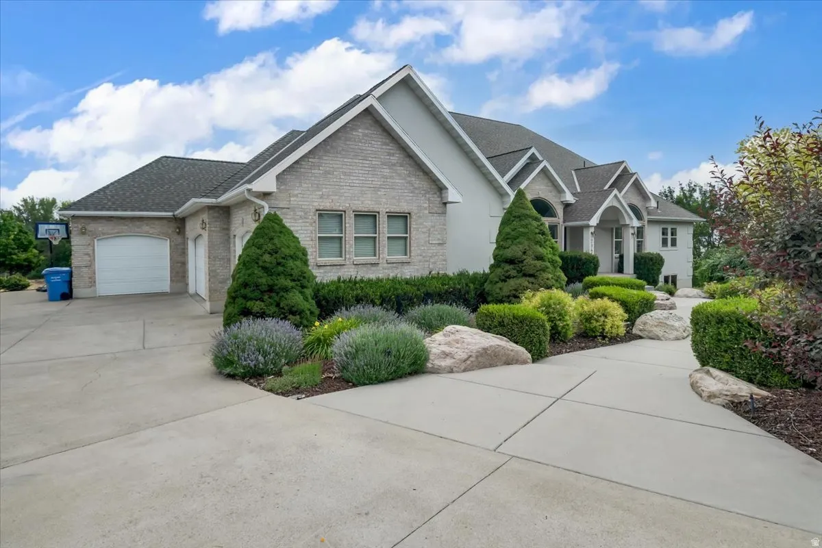 Exterior showcasing light-colored brick and stucco siding
