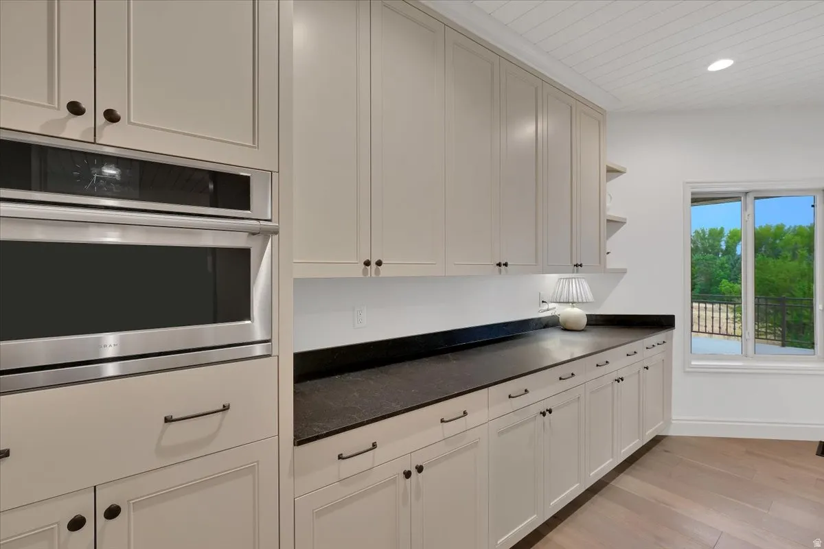 Integrated stainless steel microwave and wall oven with custom cabinetry