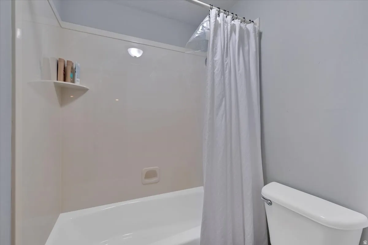 Tub/shower combination featuring a built-in corner shelf and a soap dish