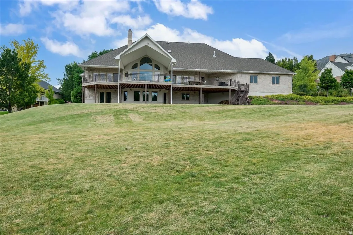 Expansive rear exterior featuring a two-story design with a walk-out lower level