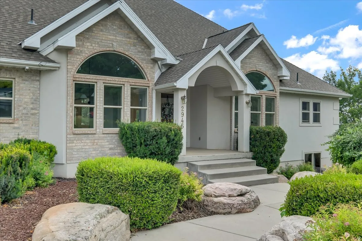 Stucco and brick exterior with a prominent arched window feature