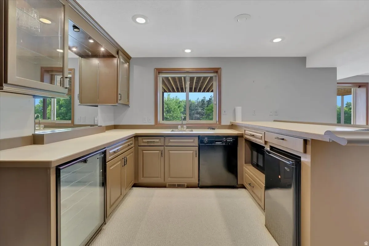 Functional kitchen area featuring light-toned cabinetry and countertops