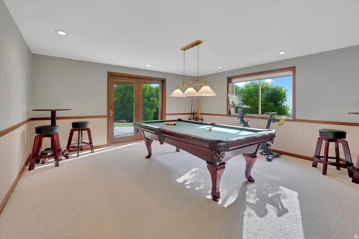 Recreation room featuring light-colored carpeting and recessed lighting