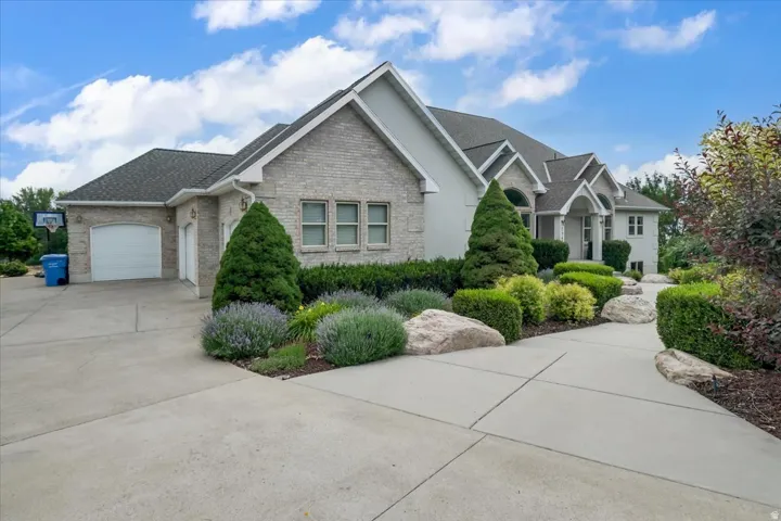 Exterior showcasing light-colored brick and stucco siding