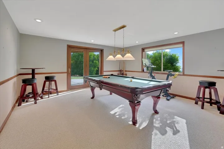 Recreation room featuring light-colored carpeting and recessed lighting