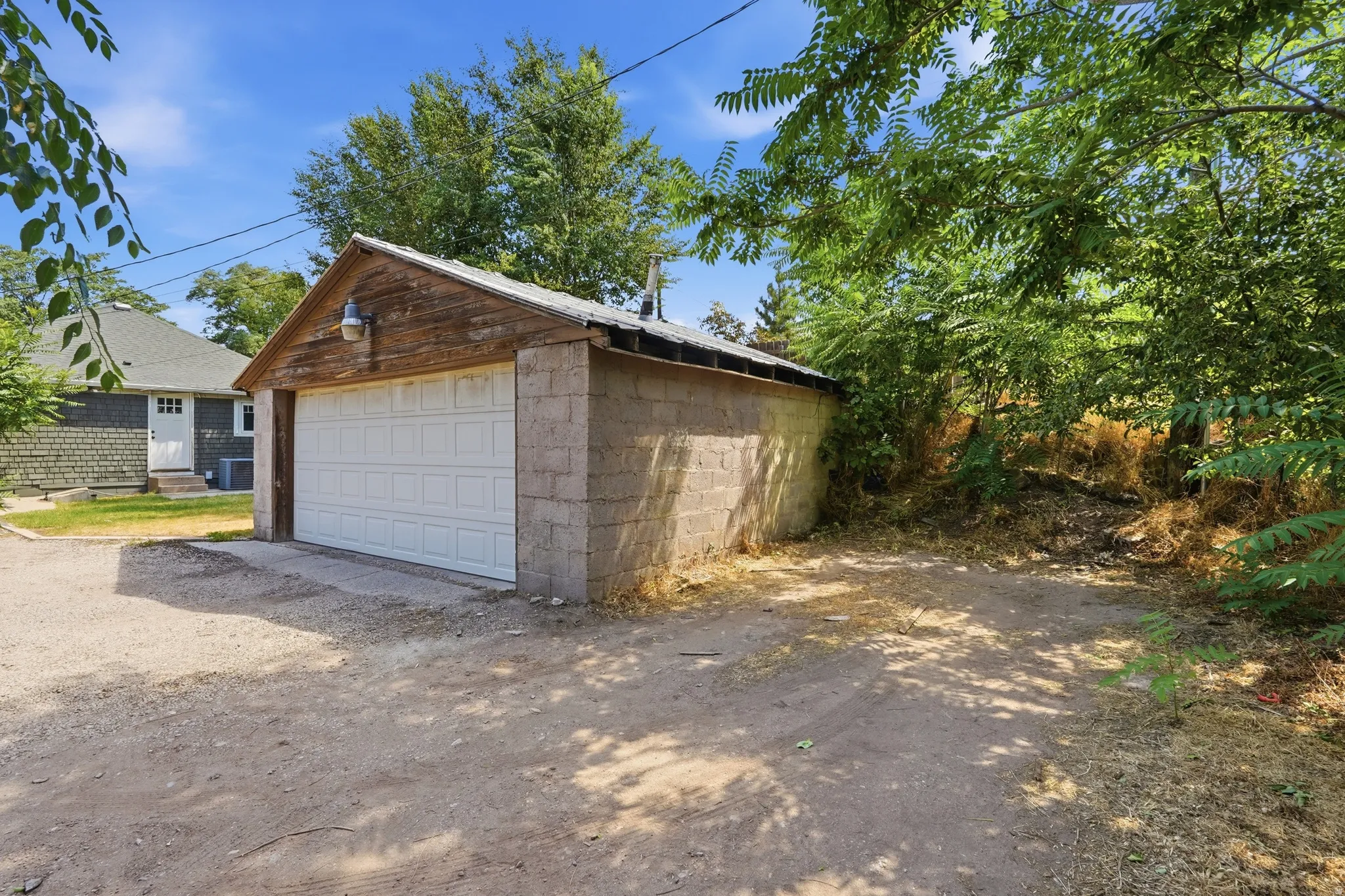 Detached garage with a paneled door and block construction