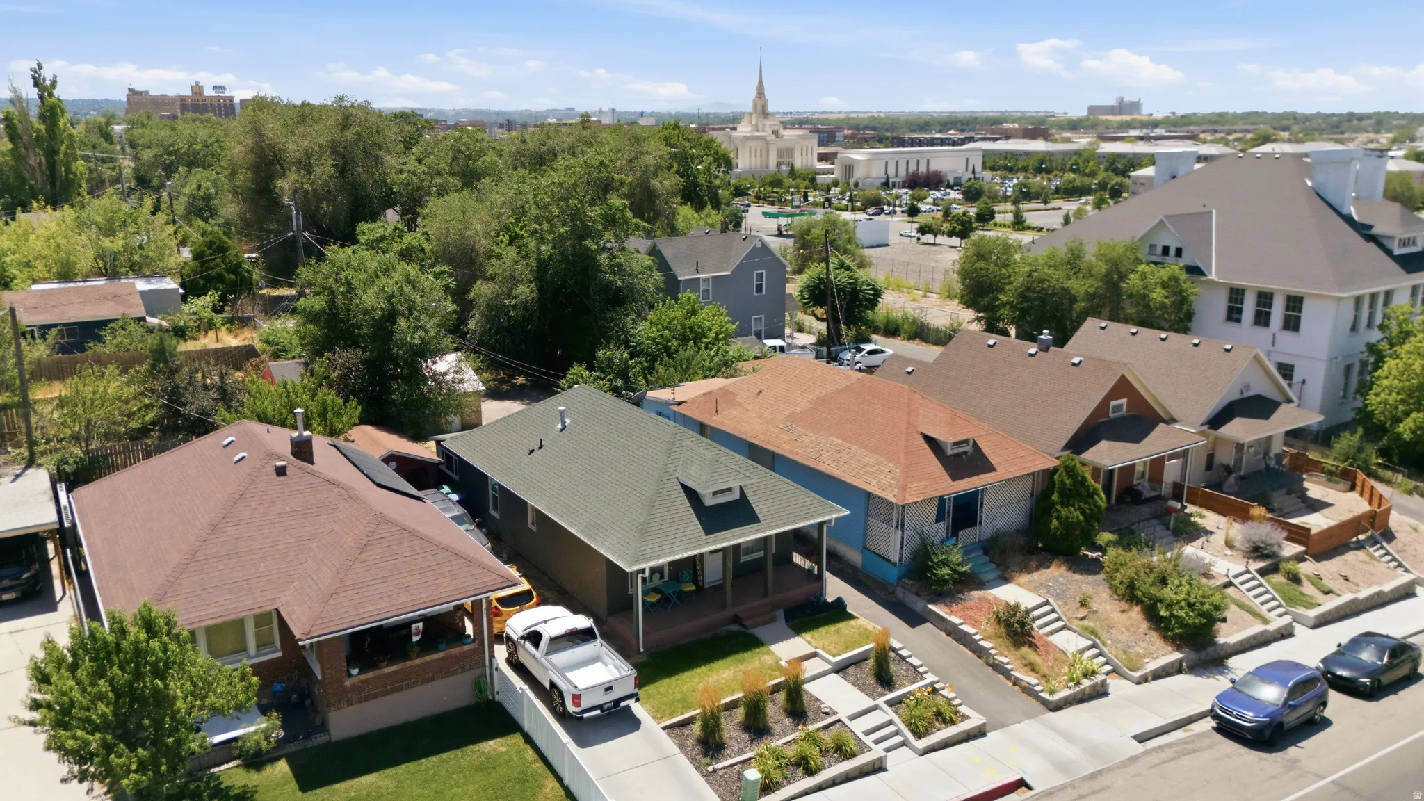 Residential street featuring multiple single-family homes with varying architectural styles and rooflines