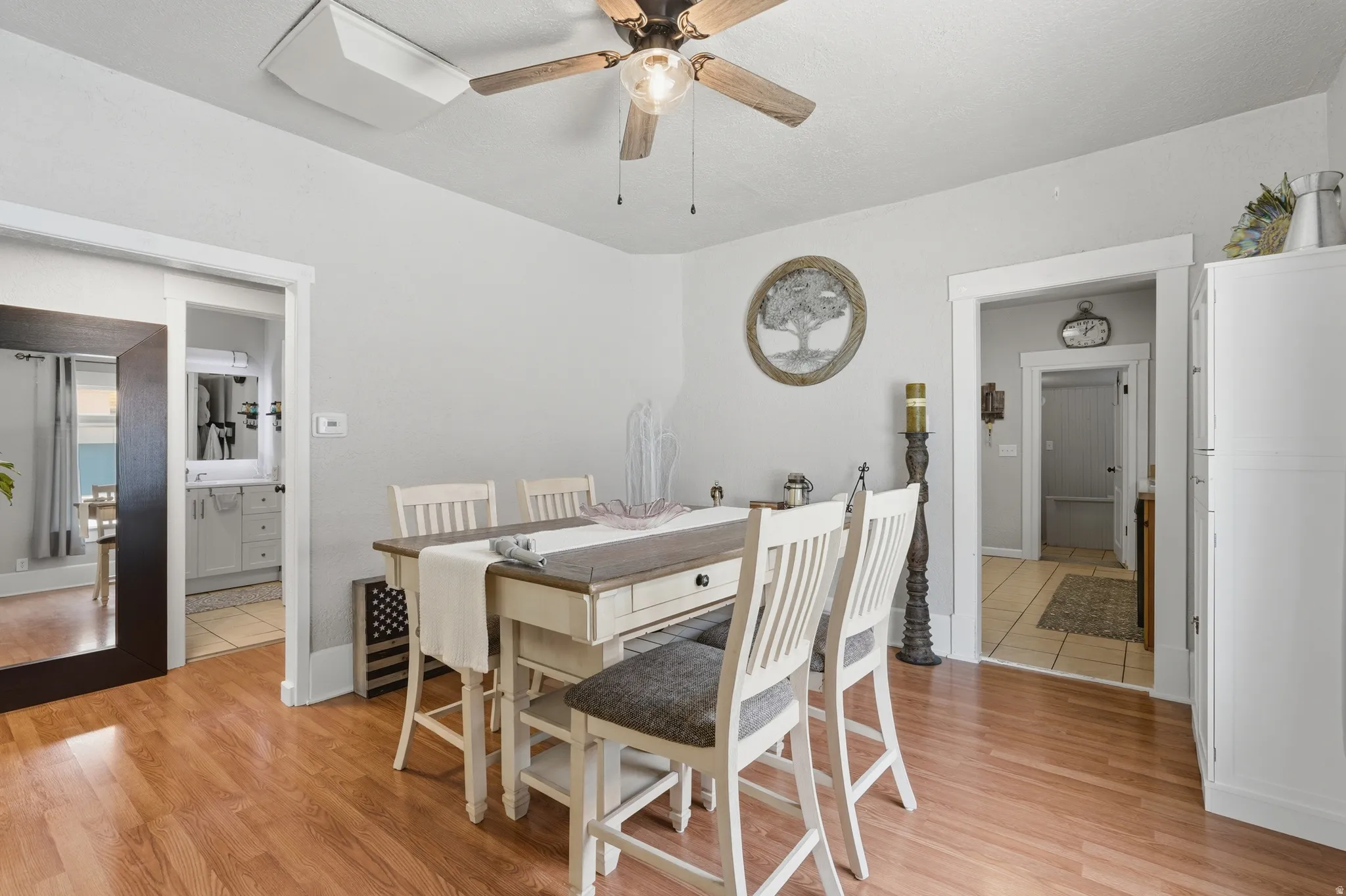 Dining area with wood-finish flooring, white trim, and light gray wall paint