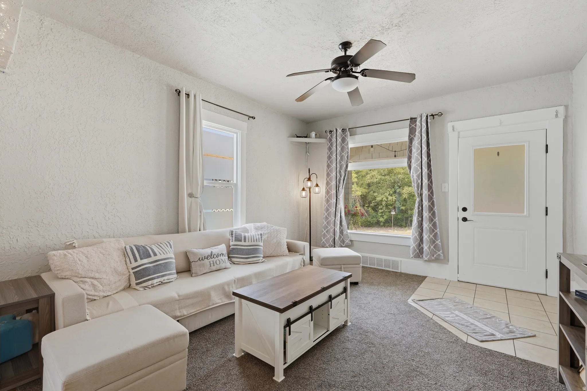 Living area featuring neutral wall tones and dark carpet flooring