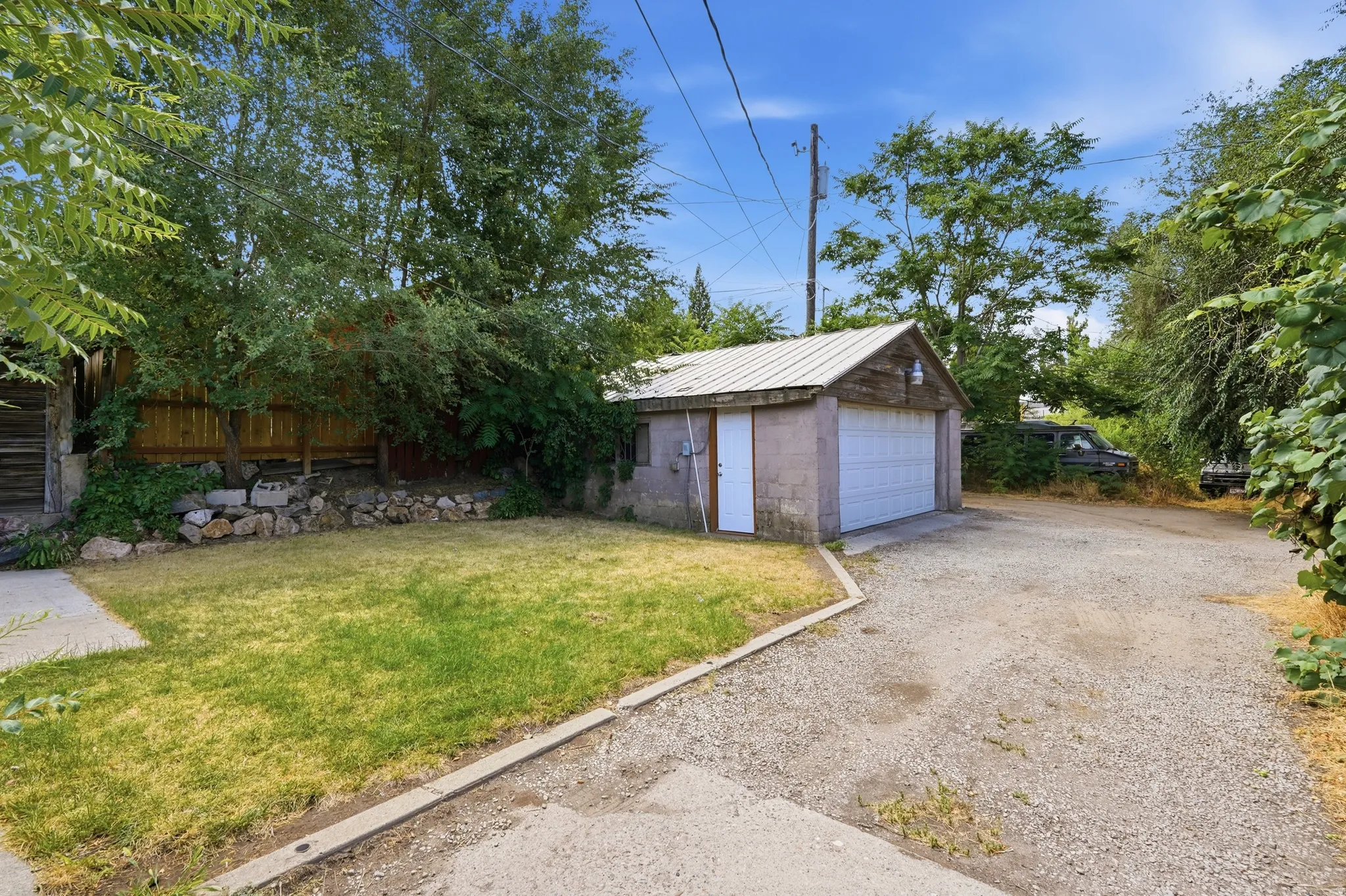 Detached garage featuring a metal roof and a single overhead door