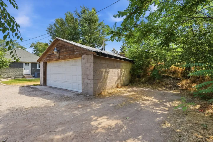 Detached garage with a paneled door and block construction