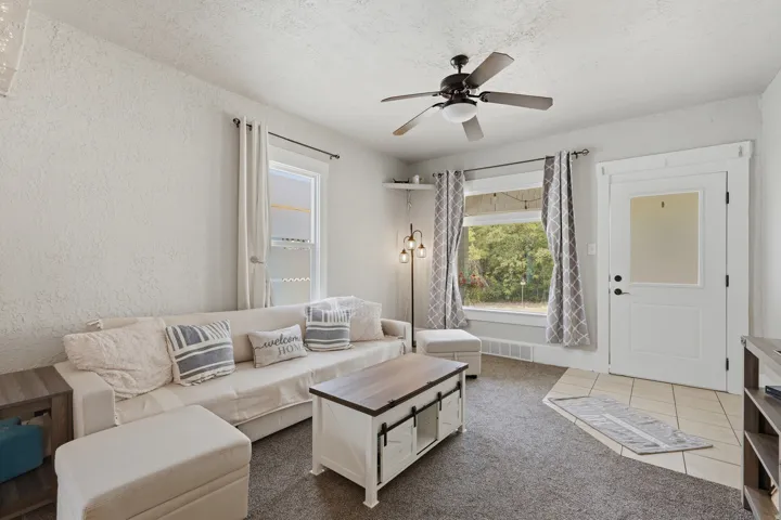 Living area featuring neutral wall tones and dark carpet flooring